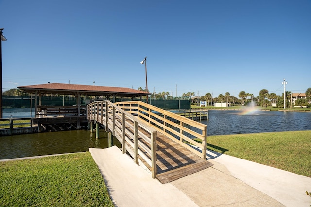 dock area with a yard and a water view