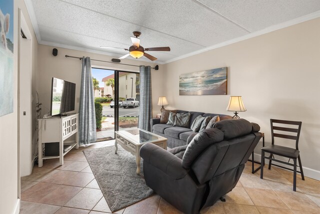 living room with ceiling fan, ornamental molding, and light tile patterned flooring