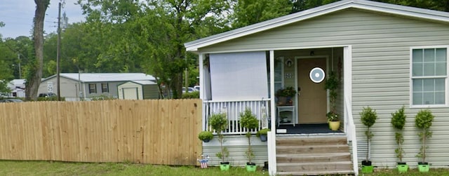 exterior space with fence and covered porch