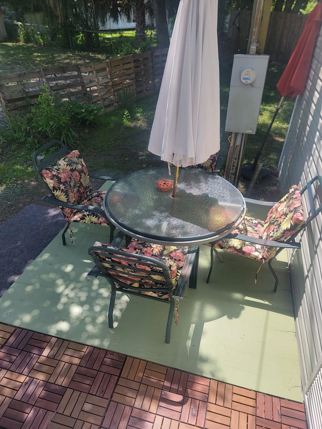 view of patio featuring fence and outdoor dining space