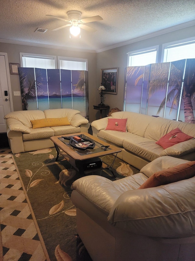 living room featuring crown molding, a ceiling fan, a textured ceiling, and visible vents