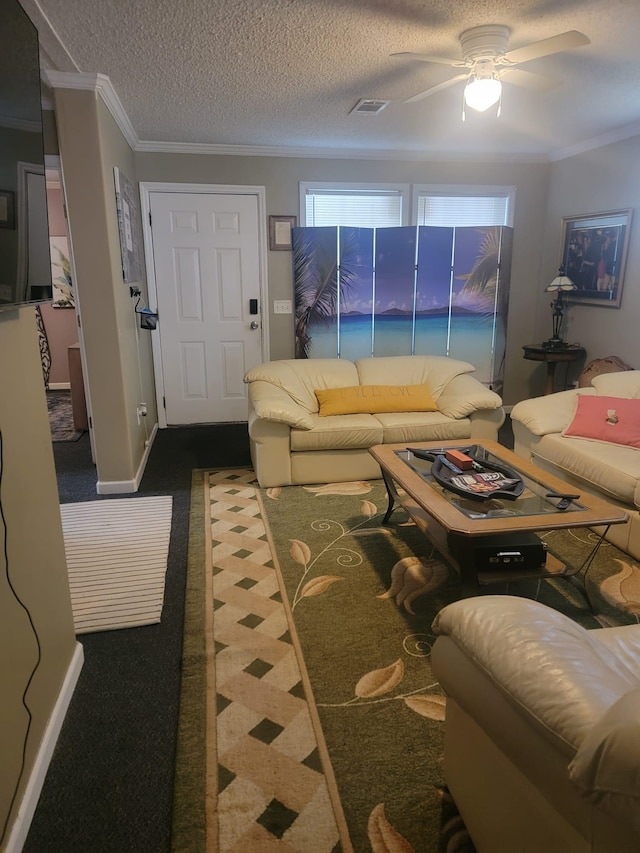 living area with crown molding, visible vents, baseboards, dark carpet, and ceiling fan