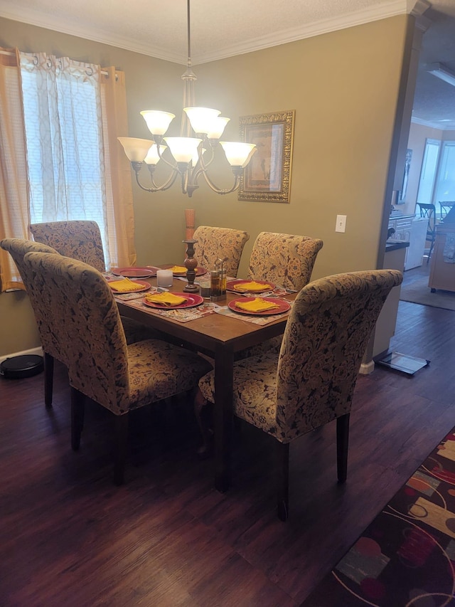 dining space featuring crown molding, wood finished floors, and a notable chandelier