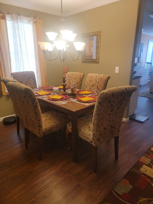 dining space featuring an inviting chandelier, ornamental molding, wood finished floors, and a healthy amount of sunlight