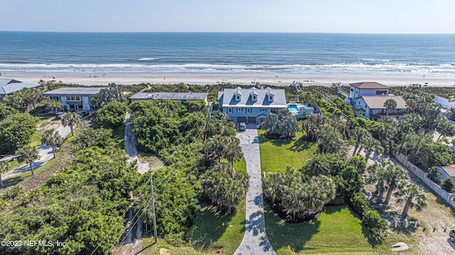 birds eye view of property featuring a water view and a beach view