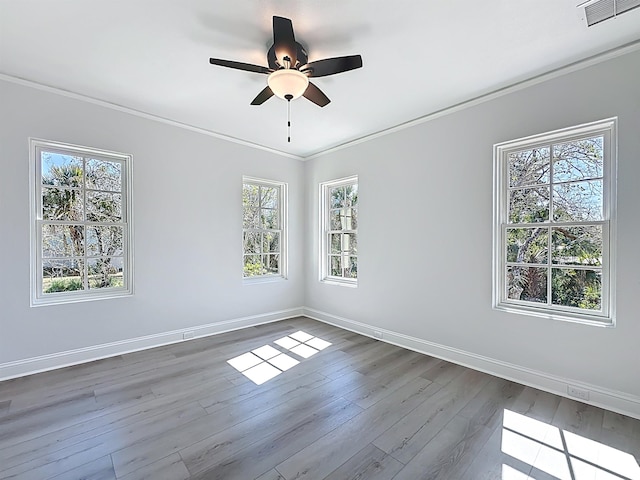 307 Minorca Ave, Saint Augustine, FL 32080 - empty room with visible vents, baseboards, ceiling fan, ornamental molding, and dark wood-type flooring