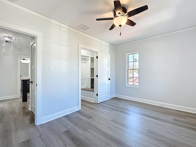 307 Minorca Ave, Saint Augustine, FL 32080 - unfurnished bedroom featuring visible vents, ornamental molding, wood finished floors, baseboards, and a spacious closet