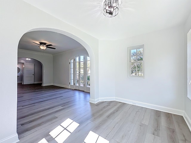 307 Minorca Ave, Saint Augustine, FL 32080 - empty room with arched walkways, baseboards, and wood finished floors