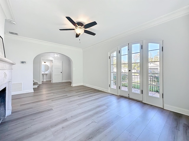 307 Minorca Ave, Saint Augustine, FL 32080 - unfurnished living room with ornamental molding, wood finished floors, visible vents, and arched walkways
