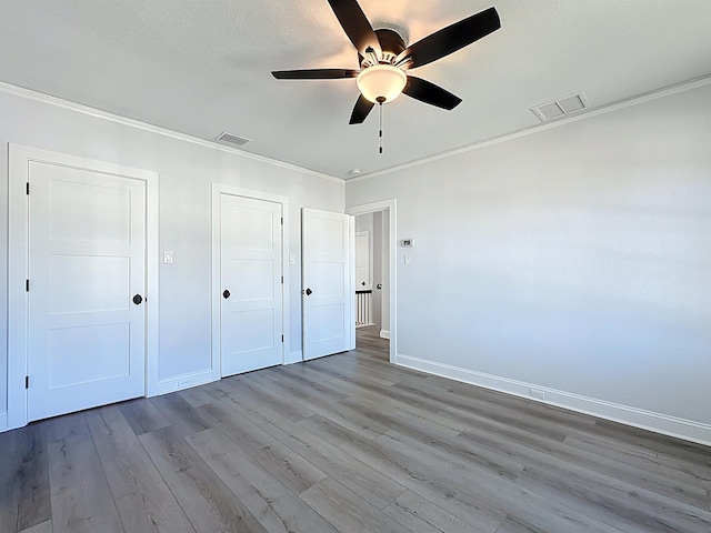 307 Minorca Ave, Saint Augustine, FL 32080 - unfurnished bedroom featuring visible vents, wood finished floors, baseboards, and ornamental molding
