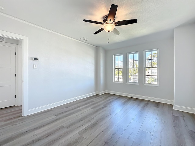 307 Minorca Ave, Saint Augustine, FL 32080 - empty room featuring visible vents, a textured ceiling, a ceiling fan, and wood finished floors