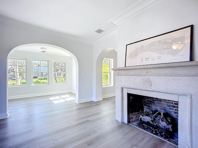 307 Minorca Ave, Saint Augustine, FL 32080 - unfurnished living room with wood finished floors, baseboards, visible vents, ornamental molding, and a tile fireplace