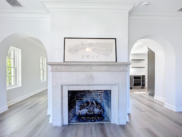 307 Minorca Ave, Saint Augustine, FL 32080 - interior details featuring visible vents, baseboards, ornamental molding, a fireplace, and wood finished floors