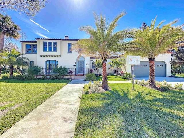 307 Minorca Ave, Saint Augustine, FL 32080 - mediterranean / spanish house featuring a front yard, french doors, driveway, and stucco siding