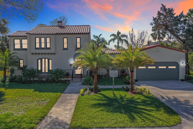 307 Minorca Ave, Saint Augustine, FL 32080 - mediterranean / spanish-style home featuring concrete driveway, a lawn, stucco siding, a chimney, and an attached garage