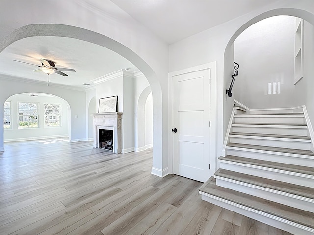 307 Minorca Ave, Saint Augustine, FL 32080 - interior space featuring baseboards, ornamental molding, a fireplace, wood finished floors, and a ceiling fan