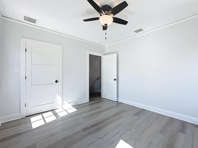 307 Minorca Ave, Saint Augustine, FL 32080 - unfurnished bedroom with light wood-style floors, visible vents, crown molding, and baseboards
