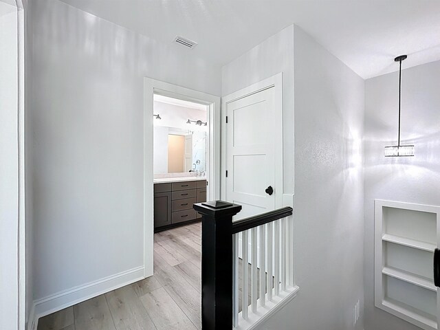 307 Minorca Ave, Saint Augustine, FL 32080 - corridor with an upstairs landing, visible vents, light wood-type flooring, and baseboards