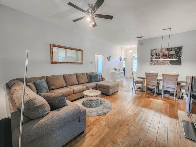 living room featuring hardwood / wood-style flooring and ceiling fan