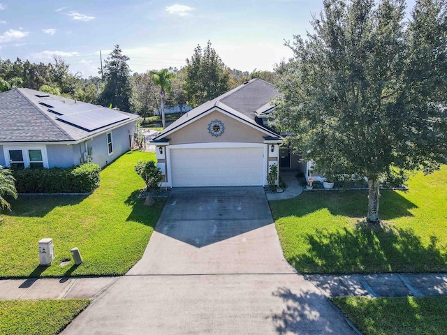 view of front of property with a front yard and a garage