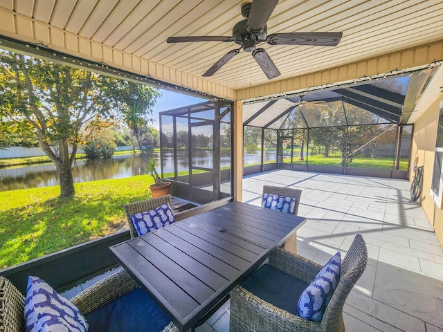 sunroom with a water view, wooden ceiling, a wealth of natural light, and vaulted ceiling