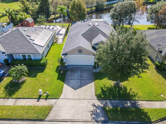 birds eye view of property with a water view