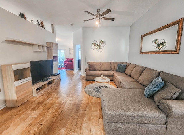 living room with wood-type flooring and ceiling fan