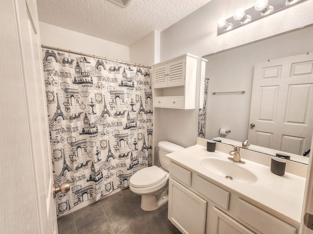 bathroom featuring vanity, a textured ceiling, toilet, and tile patterned flooring