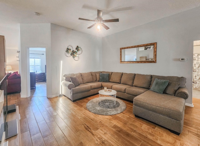 living room featuring light hardwood / wood-style floors and ceiling fan