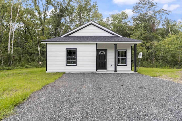 view of front facade with covered porch and a front lawn