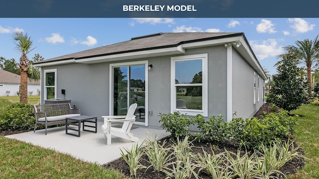 rear view of property with a patio area and stucco siding