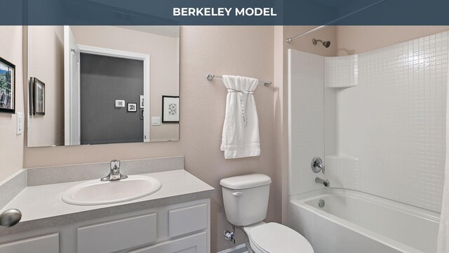 bathroom featuring toilet, vanity, and bathtub / shower combination