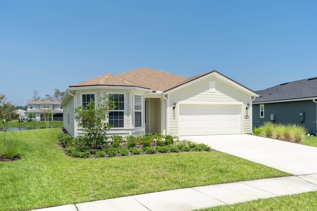 ranch-style house featuring a front yard and a garage