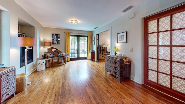 living area featuring french doors and wood-type flooring