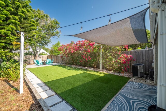 view of yard with a patio area and central AC unit