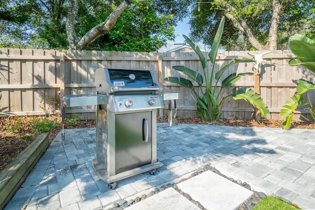 view of patio / terrace featuring a grill and fence