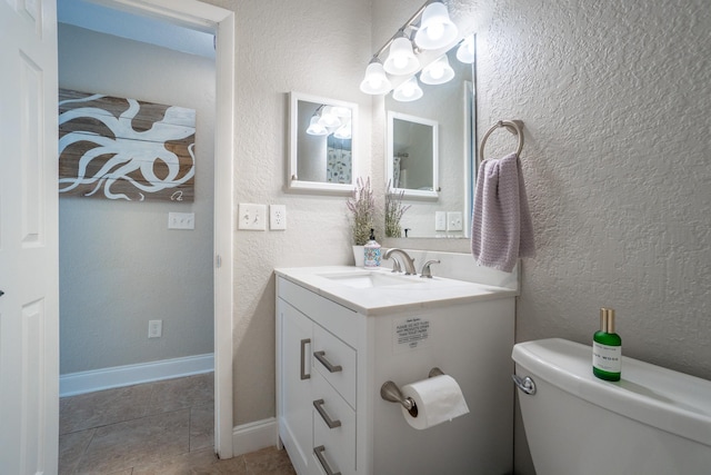 bathroom featuring vanity, toilet, and tile patterned flooring