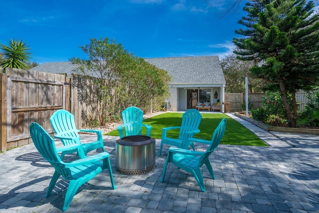 view of patio / terrace with an outdoor structure and a fire pit