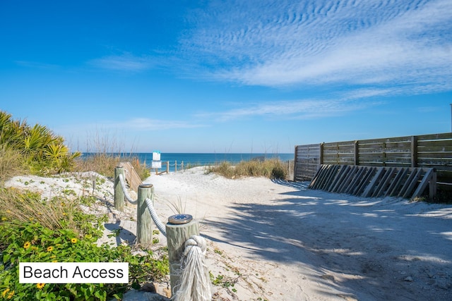 water view with nearby beach and fence