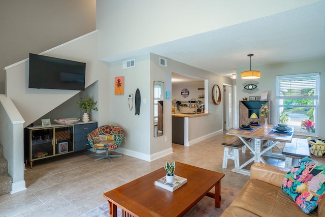 living area with light tile patterned floors and baseboards