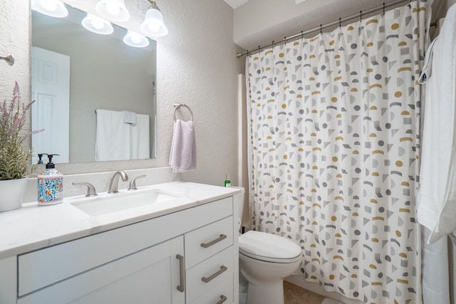 bathroom featuring a textured wall, toilet, vanity, and a shower with shower curtain