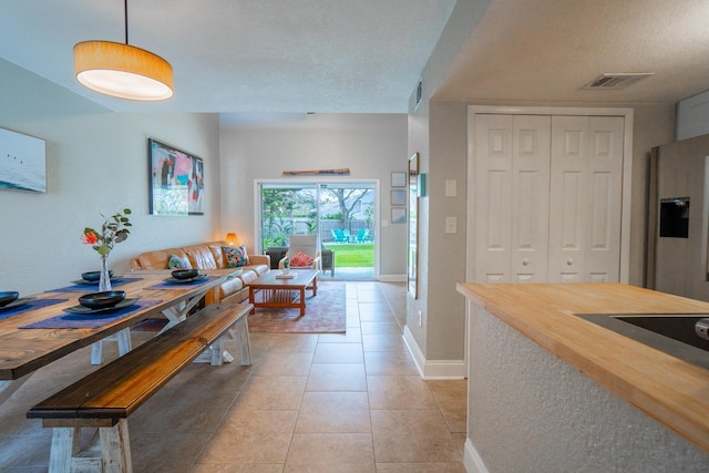 dining area with baseboards and light tile patterned flooring