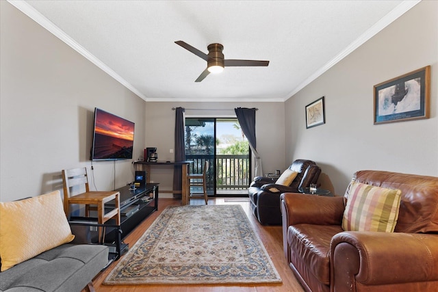 living room featuring ceiling fan, hardwood / wood-style floors, crown molding, and a textured ceiling