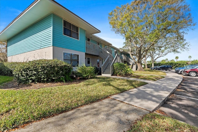 view of side of property with a lawn