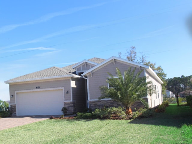 view of front of property with a front lawn and a garage