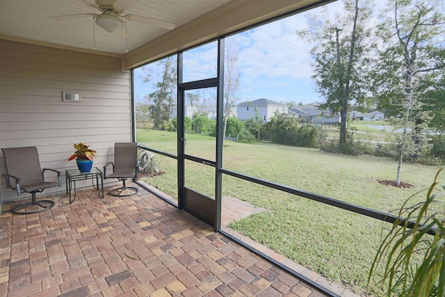 sunroom featuring ceiling fan