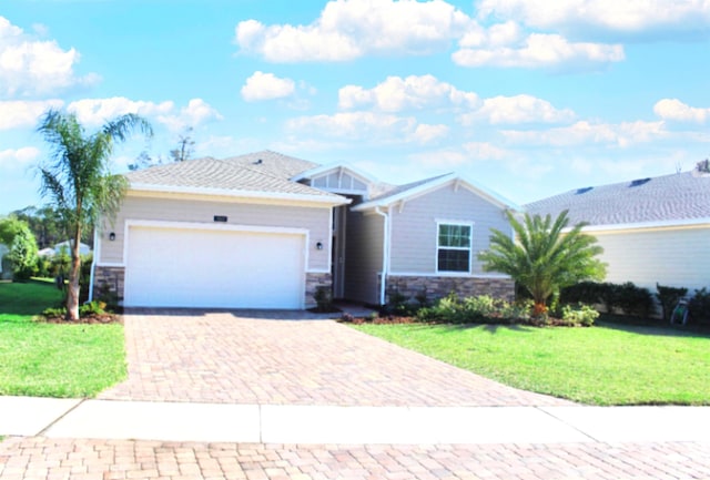 single story home with a front yard and a garage