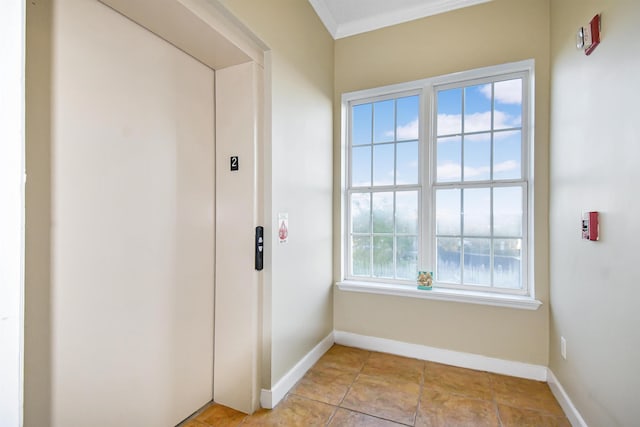 doorway to outside featuring plenty of natural light, crown molding, and elevator