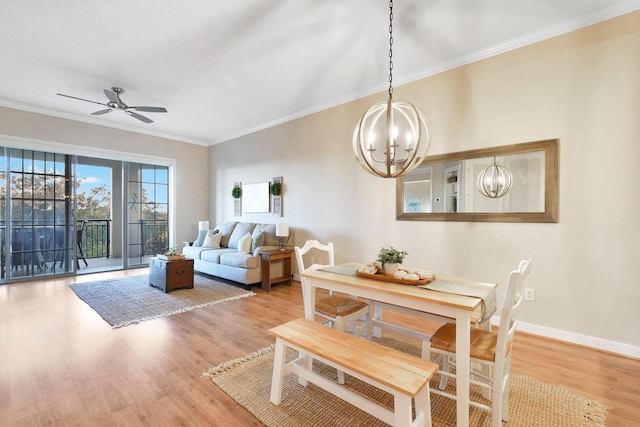 dining space featuring hardwood / wood-style floors, ceiling fan with notable chandelier, and ornamental molding