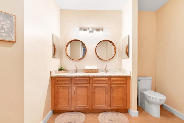 bathroom featuring tile patterned floors, vanity, and toilet